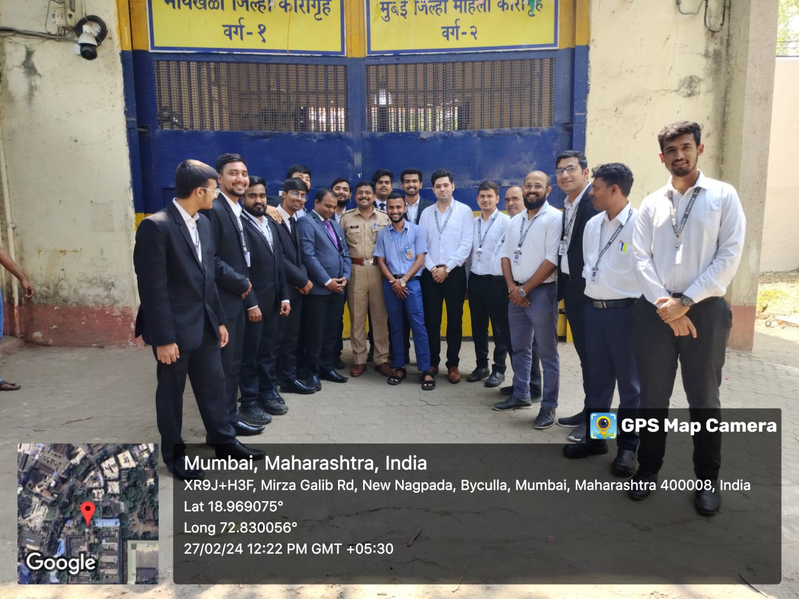 Male law students and faculty delegation outside Byculla District Prison Gate with GPS coordinates