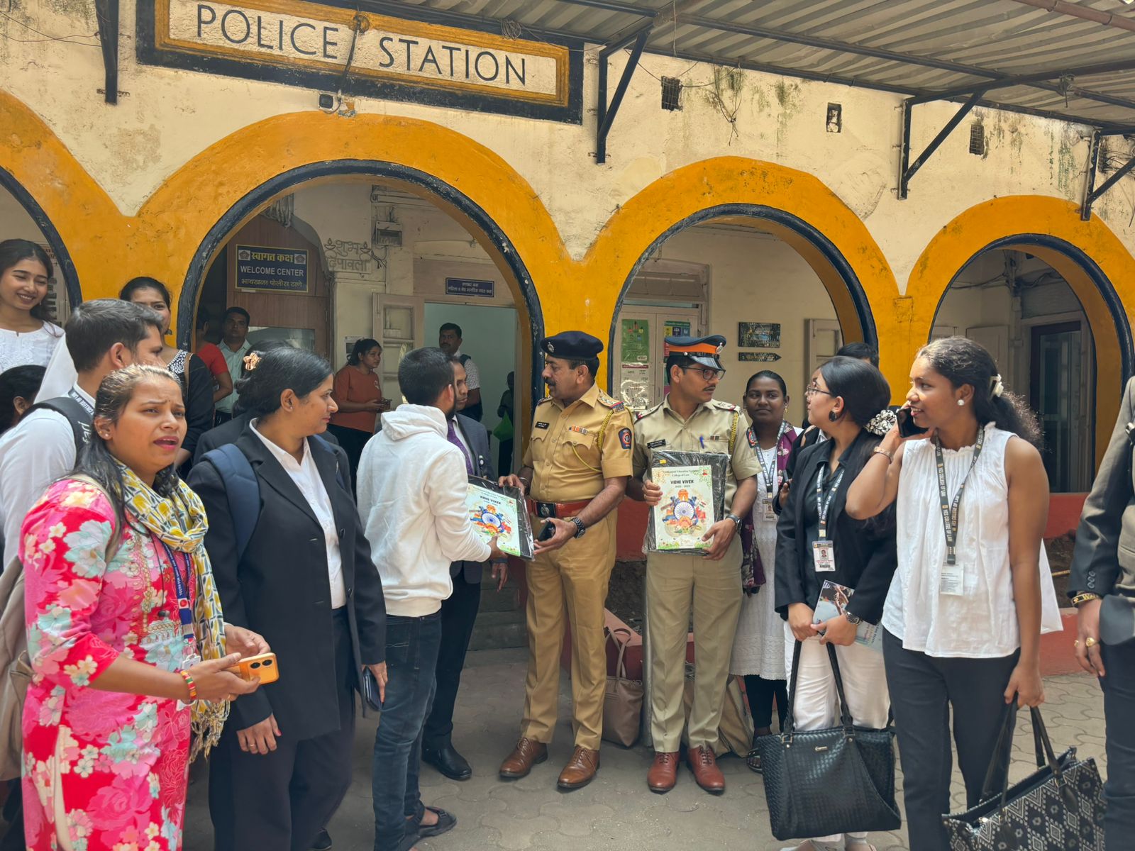 Distributing Vidhi Vivek legal aid materials and Lok Adalat flyers to police officers