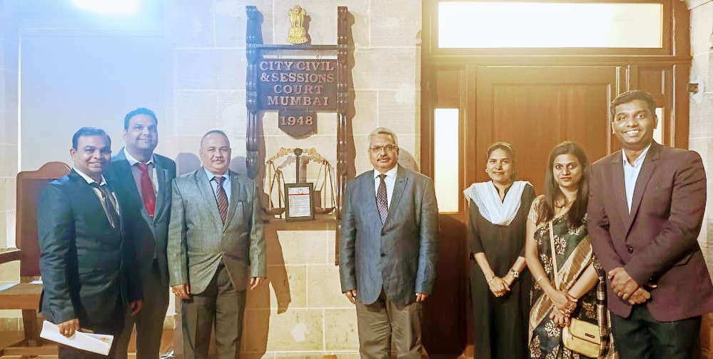 Panel Members & Judicial Officers beside 1948 Emblem
