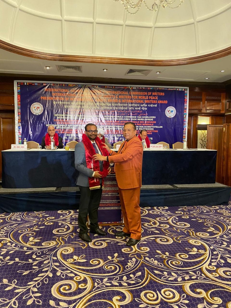 Adv. (Dr.) Swapnil Choudhary receiving ceremonial sash from Dr. Adish C. Aggarwala at International Jurists Conference London